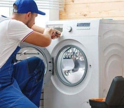 Repairman fixing a washing machine.